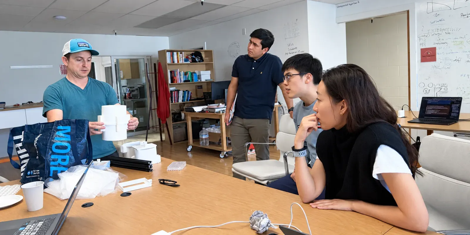 Sean sharing sample preparation hardware with builders at the Physical AI for Science build day