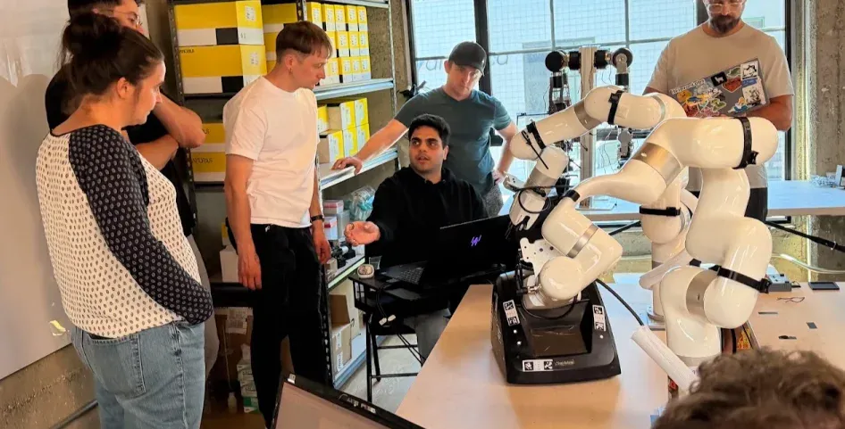A team working with two robotic arms during the open dexterity track